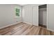 Bedroom with hardwood floors and a spacious open closet with a single window allowing natural light at 975 Memory Ln, Lawrenceville, GA 30044