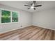 This bedroom features a modern ceiling fan, hardwood floors, and a window offering natural light at 975 Memory Ln, Lawrenceville, GA 30044