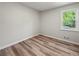 Cozy bedroom with a single window and hardwood floors creating a warm and inviting space at 975 Memory Ln, Lawrenceville, GA 30044