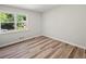 Cozy bedroom with hardwood floors and large window that provides natural light at 975 Memory Ln, Lawrenceville, GA 30044
