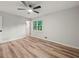 Bedroom featuring a ceiling fan, hardwood floors, and a single window offering natural lighting at 975 Memory Ln, Lawrenceville, GA 30044