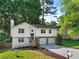 Well-maintained two-story home with a stone facade, two-car garage, landscaped front yard and driveway at 975 Memory Ln, Lawrenceville, GA 30044