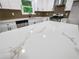 Bright kitchen features an island with white marble countertop and stainless steel appliances at 975 Memory Ln, Lawrenceville, GA 30044