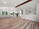 Open-concept living space with vaulted ceilings, modern lighting, and hardwood floors throughout at 975 Memory Ln, Lawrenceville, GA 30044