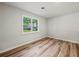 Empty room with hardwood floors, freshly painted, and a large window at 975 Memory Ln, Lawrenceville, GA 30044