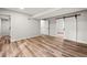 Large room features hardwood flooring, gray walls, and three doorways at 975 Memory Ln, Lawrenceville, GA 30044