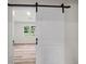 Barn door leads to a room with hardwood flooring and natural light at 975 Memory Ln, Lawrenceville, GA 30044