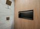 Modern shower with wood-like accent wall and sleek recessed shelf at 975 Memory Ln, Lawrenceville, GA 30044