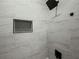 Elegant shower with gray stone-patterned tiles and a black shower head at 975 Memory Ln, Lawrenceville, GA 30044