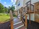 Close up outdoor staircase leading to the front door with well-manicured landscaping along the side yard at 975 Memory Ln, Lawrenceville, GA 30044