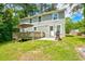 Charming home featuring a wooden deck, patio, and grill for outdoor entertaining at 174 Rivertown Rd, Fairburn, GA 30213
