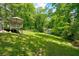 Backyard features a deck, a lawn, and a shed at 174 Rivertown Rd, Fairburn, GA 30213