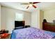 Bedroom features a ceiling fan, hardwood floors, and a dresser at 174 Rivertown Rd, Fairburn, GA 30213