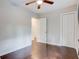 Bright bedroom with gleaming hardwood floors and a ceiling fan, offering ample closet space and easy access at 174 Rivertown Rd, Fairburn, GA 30213