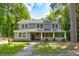 Charming two-story home with a welcoming front porch and landscaped yard at 174 Rivertown Rd, Fairburn, GA 30213