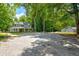 Home on a large lot features mature trees at 174 Rivertown Rd, Fairburn, GA 30213