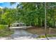 Home on a lot surrounded by mature trees at 174 Rivertown Rd, Fairburn, GA 30213