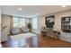 Inviting home office with natural light, offering a great workspace with modern decor and hardwood floors at 174 Rivertown Rd, Fairburn, GA 30213