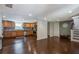 Open kitchen with stainless steel appliances, wood cabinets and hardwood floors at 174 Rivertown Rd, Fairburn, GA 30213