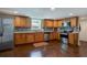 Well-lit kitchen with stainless steel appliances, wood cabinets and tile backsplash at 174 Rivertown Rd, Fairburn, GA 30213