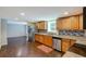 Spacious kitchen with wooden cabinets, stainless steel appliances, and tile backsplash at 174 Rivertown Rd, Fairburn, GA 30213