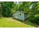 Backyard shed is surrounded by trees and green space at 174 Rivertown Rd, Fairburn, GA 30213