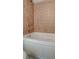 Close-up of the bathtub with tiled backsplash, toilet, and faucet at 238 Walker Sw St # 32, Atlanta, GA 30313