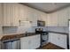 Modern kitchen with white cabinets, granite countertops, stainless steel appliances, and tile backsplash at 238 Walker Sw St # 32, Atlanta, GA 30313