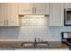 Up close view of kitchen features, including a double sink, granite countertop, and subway tile backsplash at 238 Walker Sw St # 32, Atlanta, GA 30313