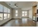 Bright living room featuring wood flooring, large windows, and stainless steel appliances at 238 Walker Sw St # 32, Atlanta, GA 30313