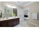 Clean bathroom featuring a double vanity, tile floors, and natural light at 4371 Wigley Preserve Dr, Marietta, GA 30066