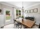 Charming dining area with wainscoting, garden view and an elegant chandelier at 4371 Wigley Preserve Dr, Marietta, GA 30066