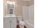 Clean bathroom featuring a vanity with modern fixtures, a toilet, and a bathtub with tiled walls at 8989 Teal Ln, Jonesboro, GA 30236