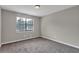 Bedroom featuring neutral colored walls and plush carpet and large window at 8989 Teal Ln, Jonesboro, GA 30236