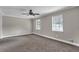 Bright bedroom offering two windows, a ceiling fan, neutral walls, and plush carpeting at 8989 Teal Ln, Jonesboro, GA 30236