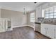 Bright kitchen features stainless steel appliances, window and sleek countertops at 8989 Teal Ln, Jonesboro, GA 30236