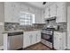 Bright kitchen features stainless steel appliances, sleek counters and white cabinets at 8989 Teal Ln, Jonesboro, GA 30236
