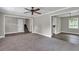 Open living room featuring neutral walls, hardwood floors, and entryways to other rooms at 8989 Teal Ln, Jonesboro, GA 30236
