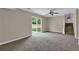 Open living room features plush carpet, neutral paint, backyard access, and stairway to second floor at 8989 Teal Ln, Jonesboro, GA 30236
