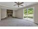Spacious living room with a stone fireplace and sliding glass door to the backyard at 8989 Teal Ln, Jonesboro, GA 30236