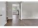 Open living room featuring hardwood floors, neutral walls, with dining area and kitchen views at 8989 Teal Ln, Jonesboro, GA 30236