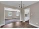 Open living room featuring hardwood floors, neutral walls, with dining area and kitchen views at 8989 Teal Ln, Jonesboro, GA 30236