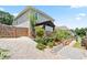 Landscaped backyard with a stone terrace, garden beds, and privacy fence at 3735 Turnbury Oaks Dr, Peachtree Corners, GA 30096