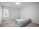 Neutral bedroom with window, carpet, and small bed at 3735 Turnbury Oaks Dr, Peachtree Corners, GA 30096