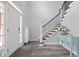 Bright entryway with hardwood floors and staircase with white risers and black metal railings at 3735 Turnbury Oaks Dr, Peachtree Corners, GA 30096