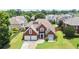 Beautiful two-story home with a brick exterior, a three-car garage, and well-manicured lawn at 3735 Turnbury Oaks Dr, Peachtree Corners, GA 30096