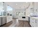 Open kitchen features white cabinetry, an island with seating, and stainless appliances at 3735 Turnbury Oaks Dr, Peachtree Corners, GA 30096