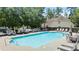 Community pool with lounge chairs and umbrellas for relaxing on a sunny day at 3735 Turnbury Oaks Dr, Peachtree Corners, GA 30096