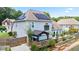 Home exterior featuring solar panels, deck with pergola, and raised garden beds at 3735 Turnbury Oaks Dr, Peachtree Corners, GA 30096