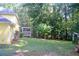 Expansive backyard with mature trees and a screened in back porch at 150 Ashley Dr, Fayetteville, GA 30214